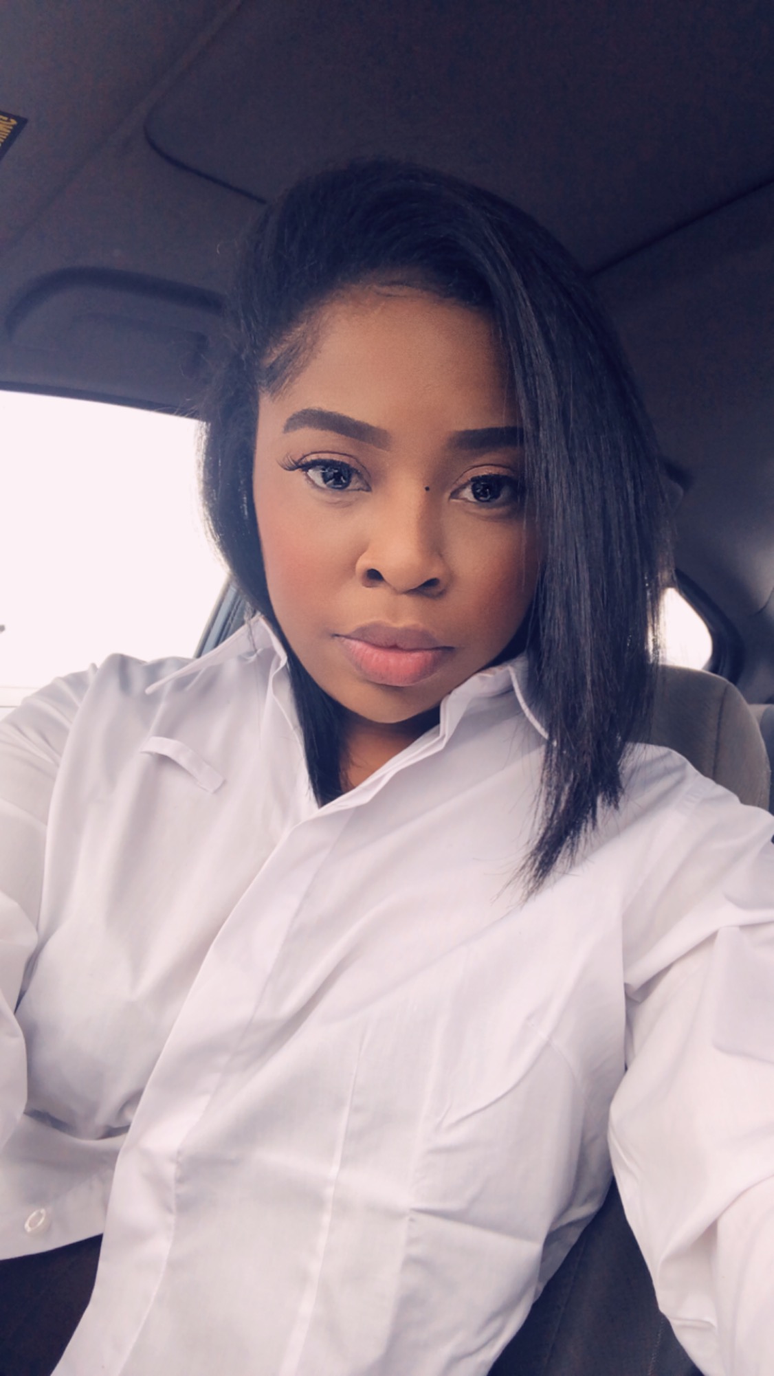 Editorial studio portrait of KB seated in denim and black top